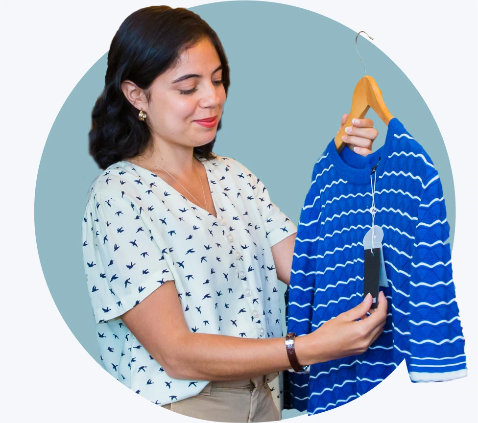 Shop owner holding clothing